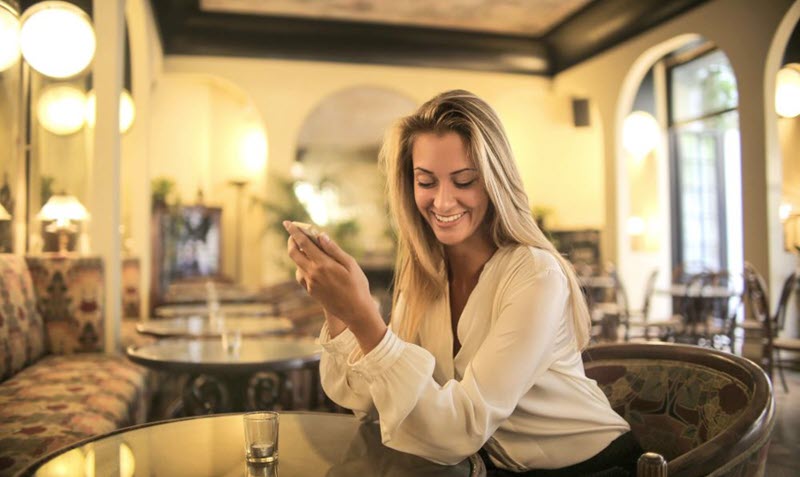 Woman smiling with a phone