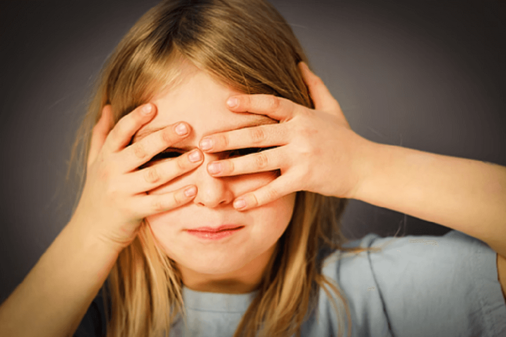 Girl Covering Eyes with Two Hands when Seeing Harmful Contents