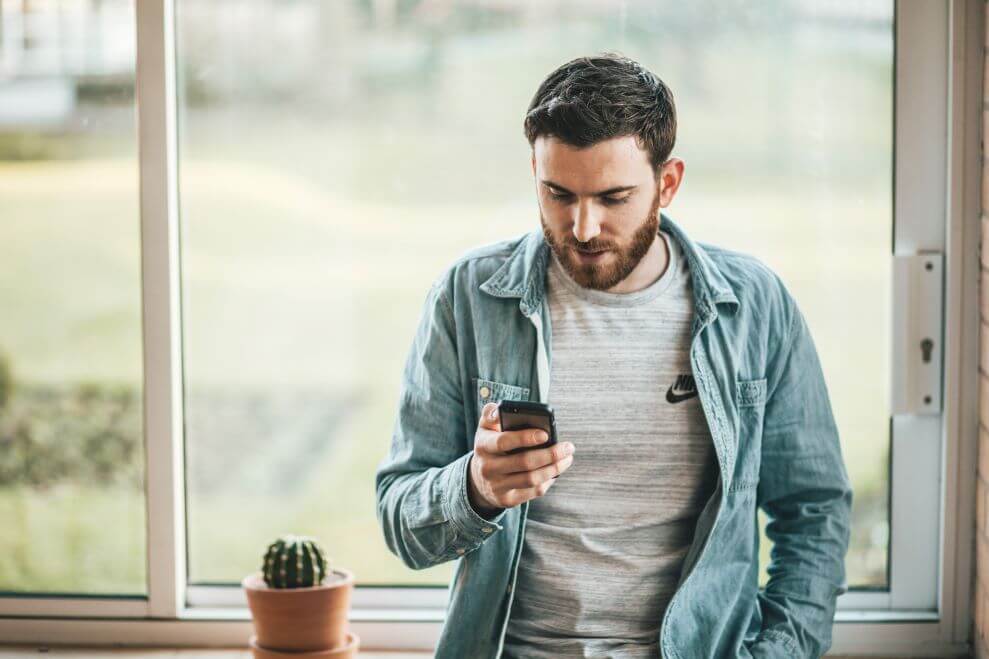 A Man Checks Phone