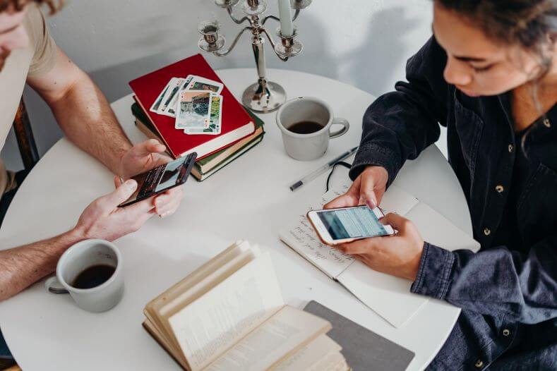 Two People Use Phones